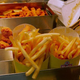 Wendy's french fries waiting in metal tray in restaurant kitchen